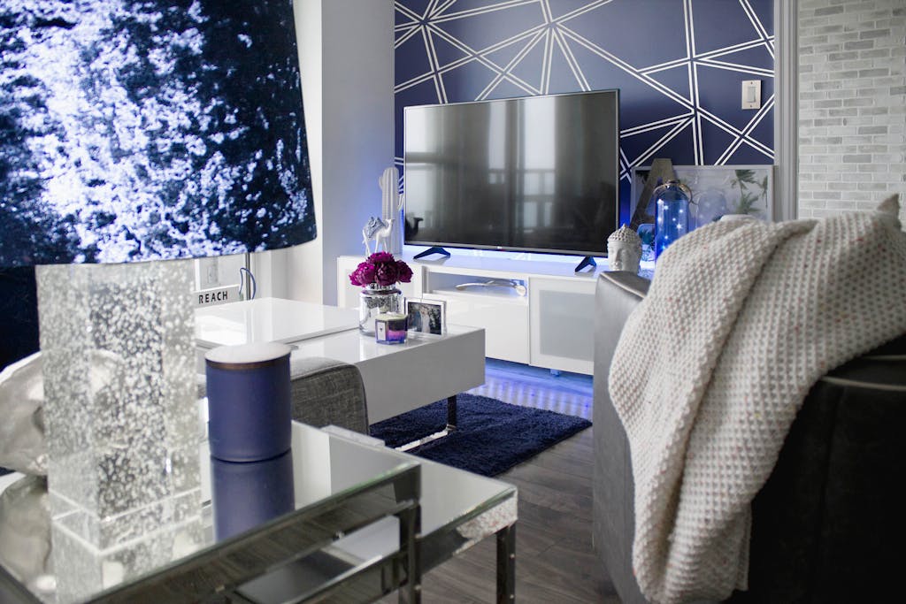 Stylish Toronto living room featuring geometric wallpaper and contemporary decor.